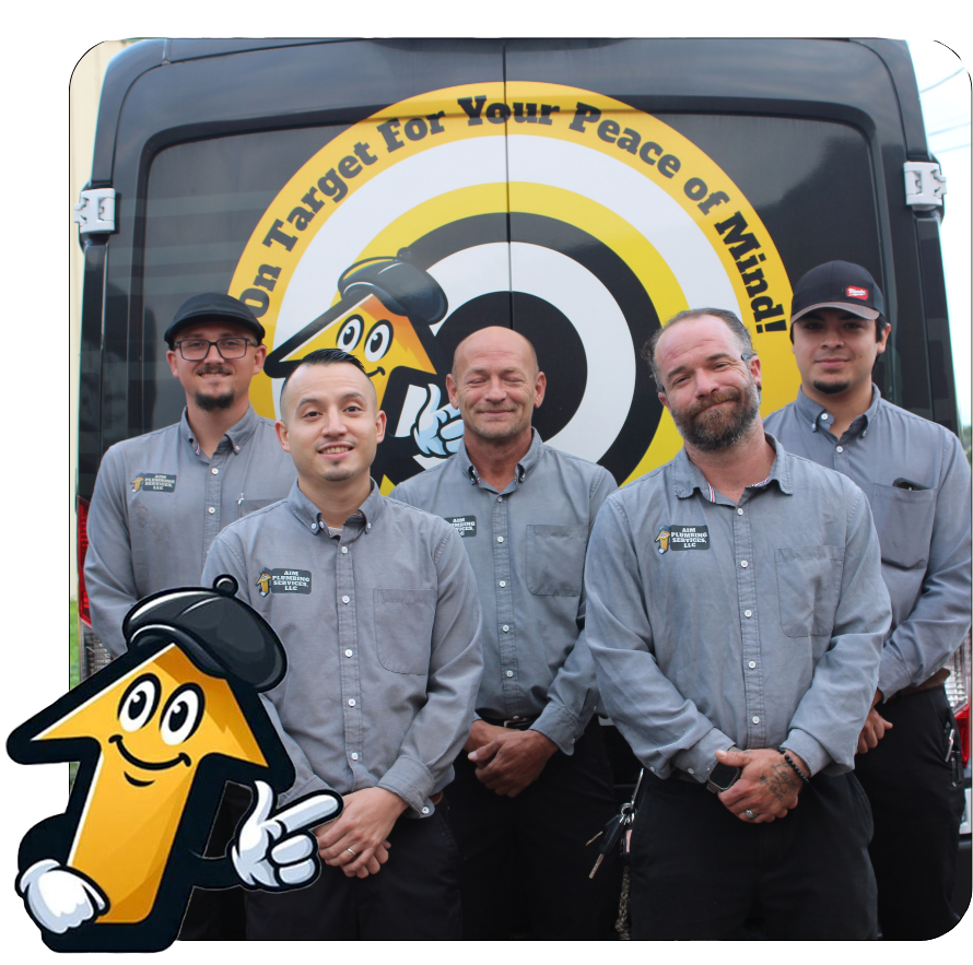 Men in blue shirts stand in front of a van with 