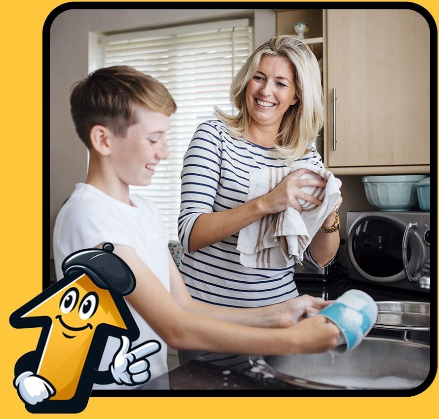 Woman dries dishes while teen washes them at a kitchen sink.