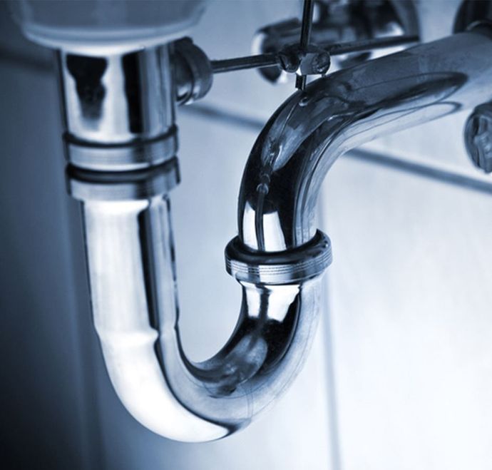 Chrome plumbing pipes under a sink.