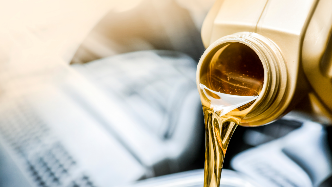 Golden liquid pouring from a bottle into an open book, suggesting reading or literature metaphor