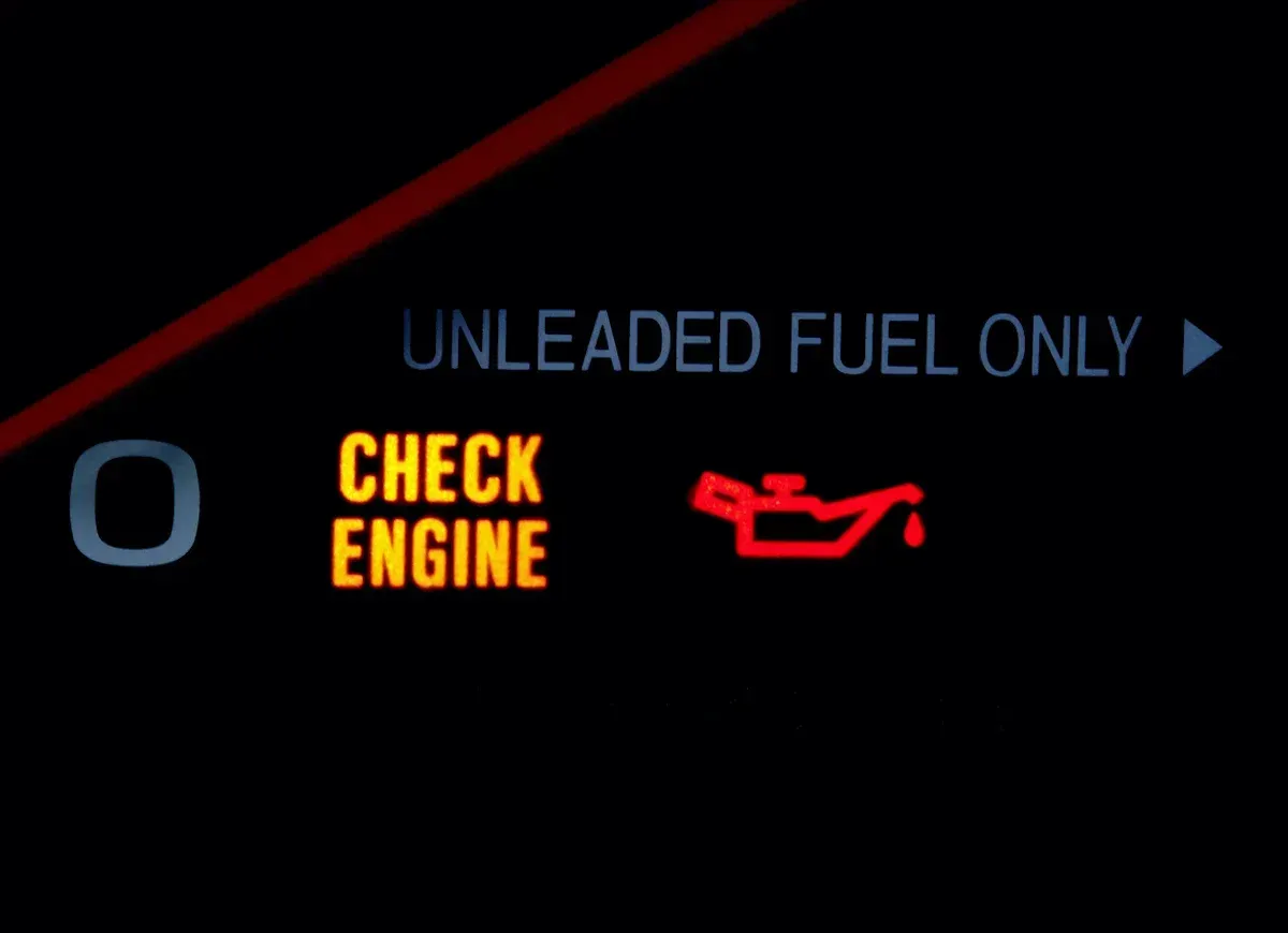 Car dashboard warning lights: amber check engine and red oil pressure icons, with โunleaded fuel onlyโ text.