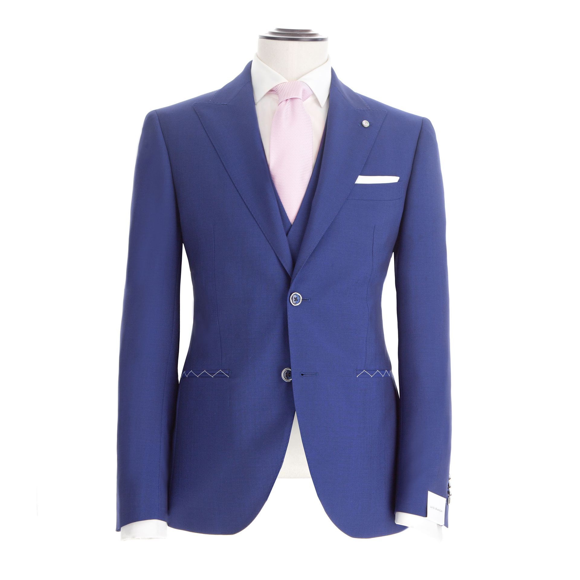 Abito blu su manichino con cravatta rosa e fazzoletto da taschino.
