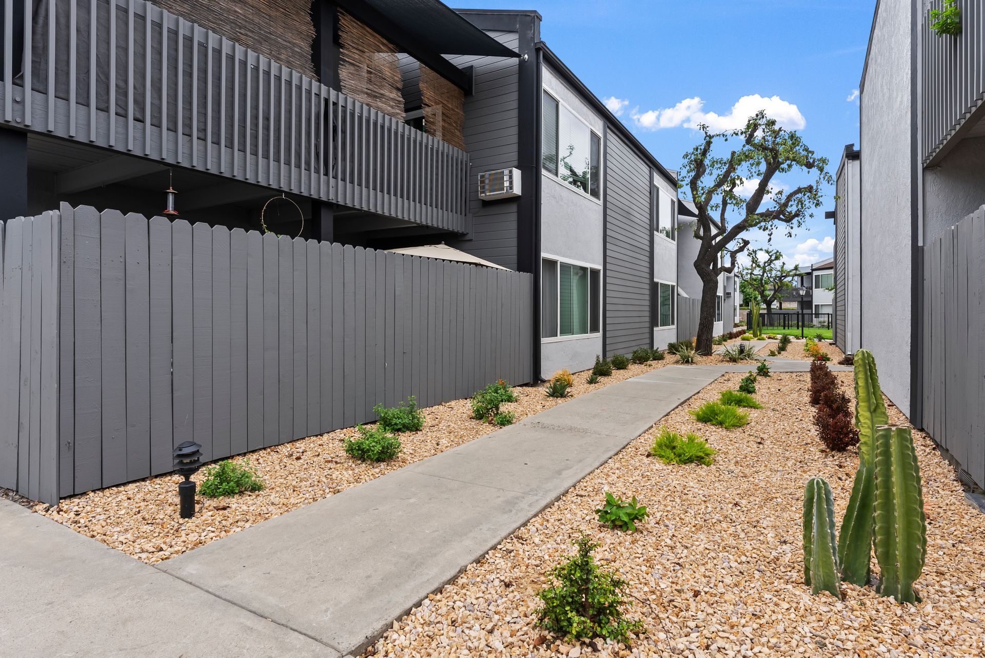 Exterior photo of The Edward Apartments -Walkway with apartments in background