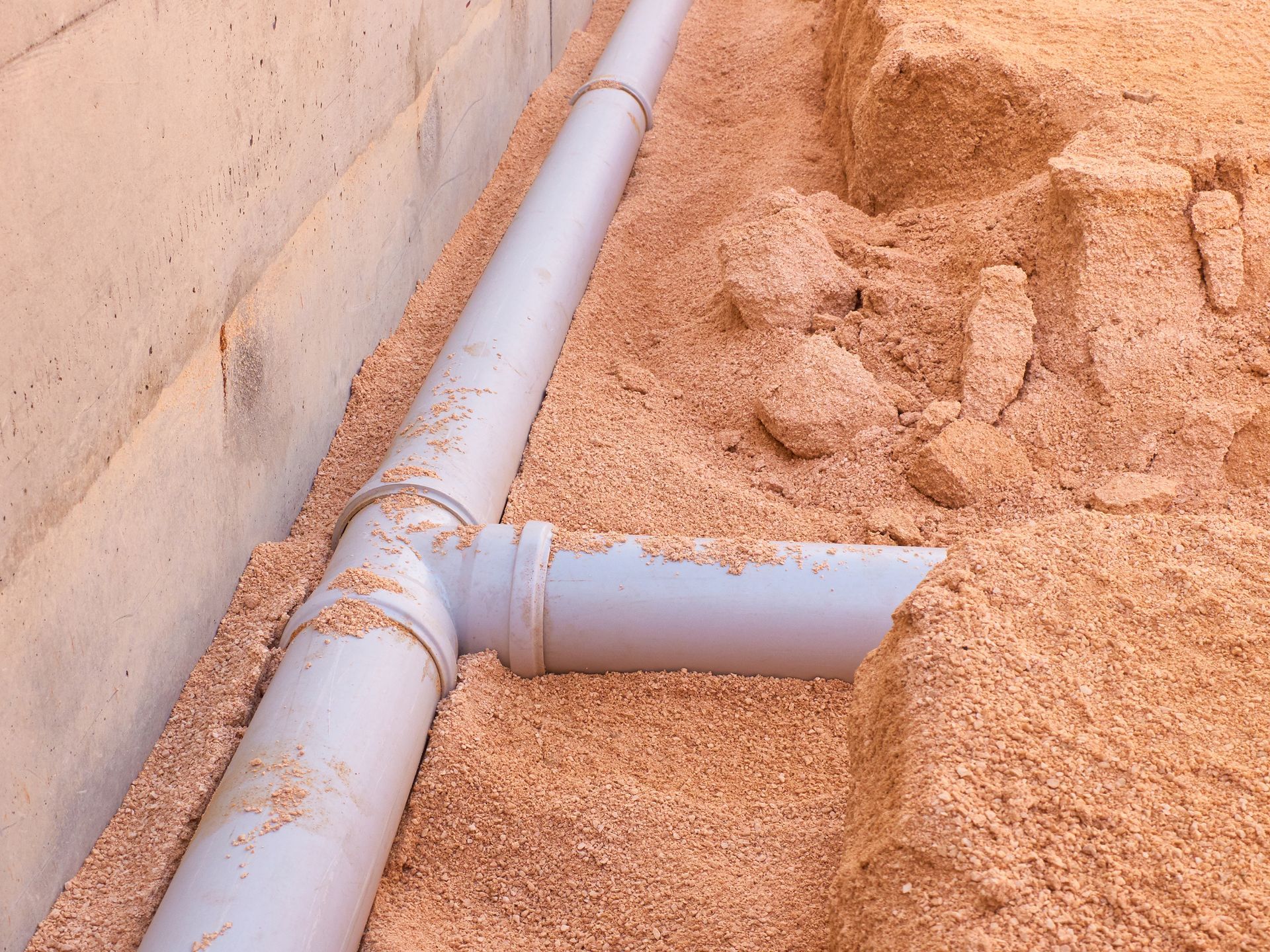 PVC Sewer line of a home in the middle of construction, on the loose ground. PVC Sewer line of a home in the middle of construction, on the loose ground.