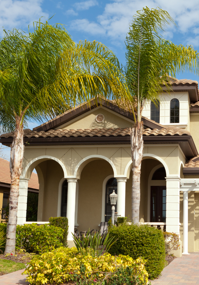 A large house with palm trees in front of it