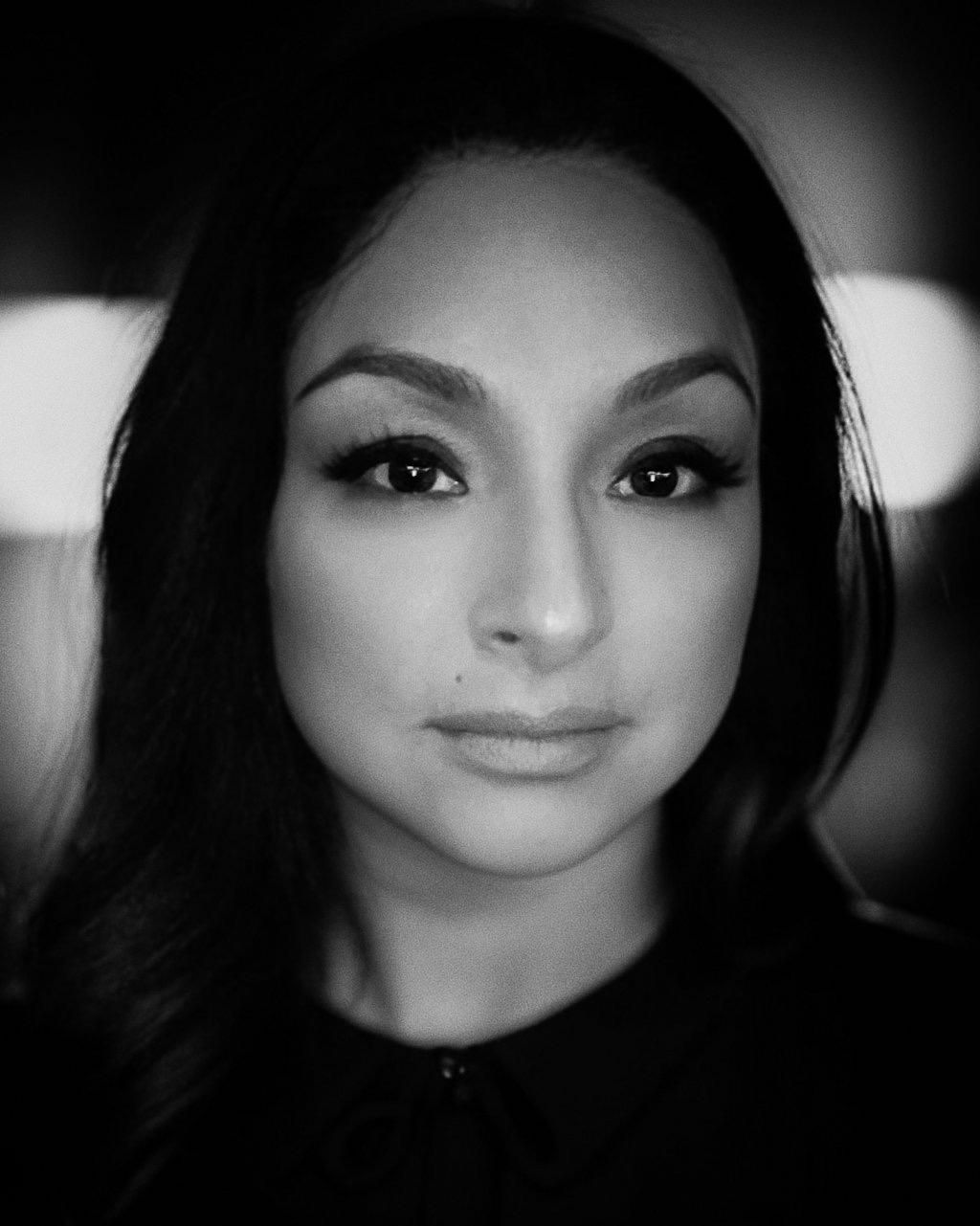 A black and white photo of a woman 's face.