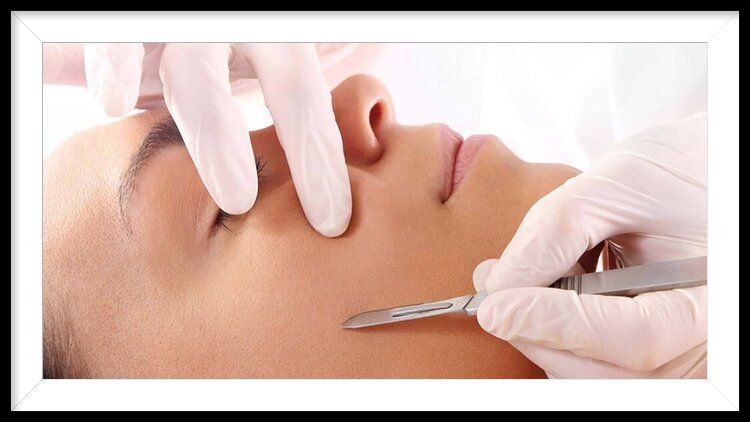 A woman is getting a facial treatment with a scalpel.