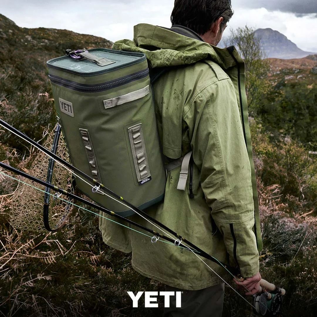 Man in Green Jacket Hiking With a Green Yeti Backpack — True Blue Camping Warehouse in North Mackay, QLD