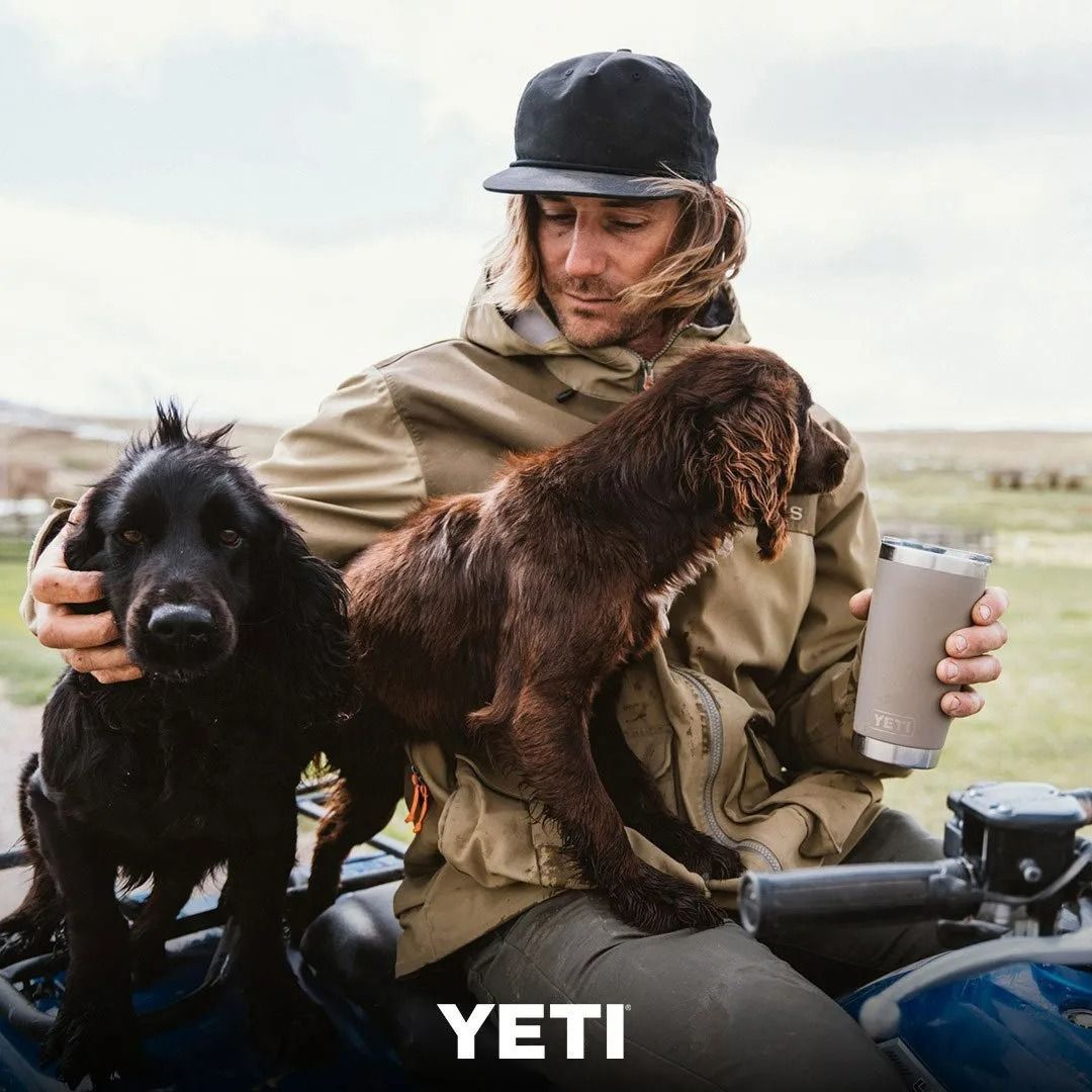 Man in Outdoor Gear Holds Two Dogs and a Yeti Tumbler on an Atv — True Blue Camping Warehouse in North Mackay, QLD
