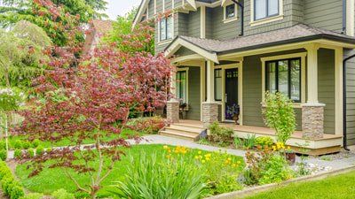 Picture of a house with green vinyl siding in Trenton Ontario.