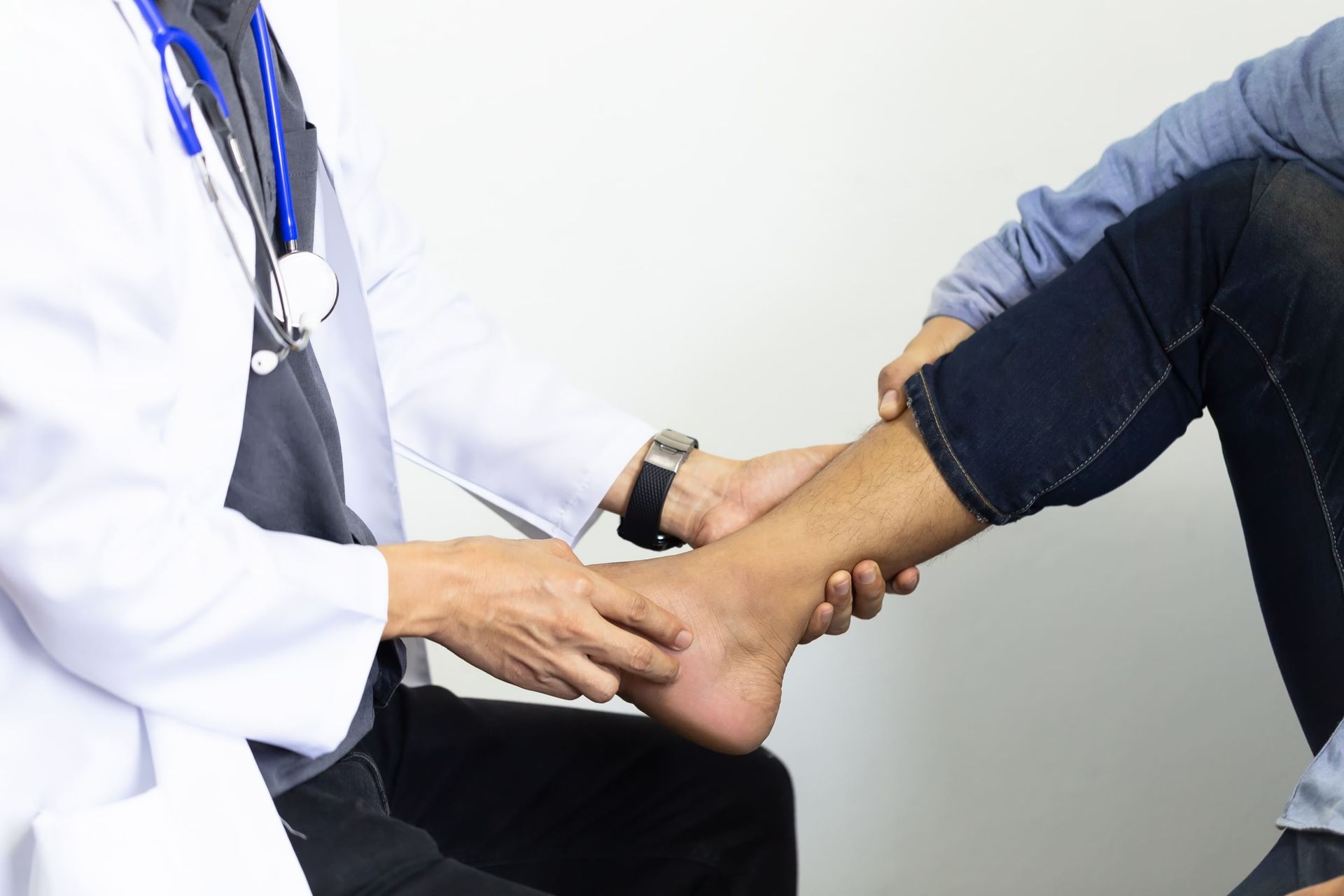 A Doctor is Examining a Patient's Foot — Craig Hughes Podiatry in Mount Hutton, NSW