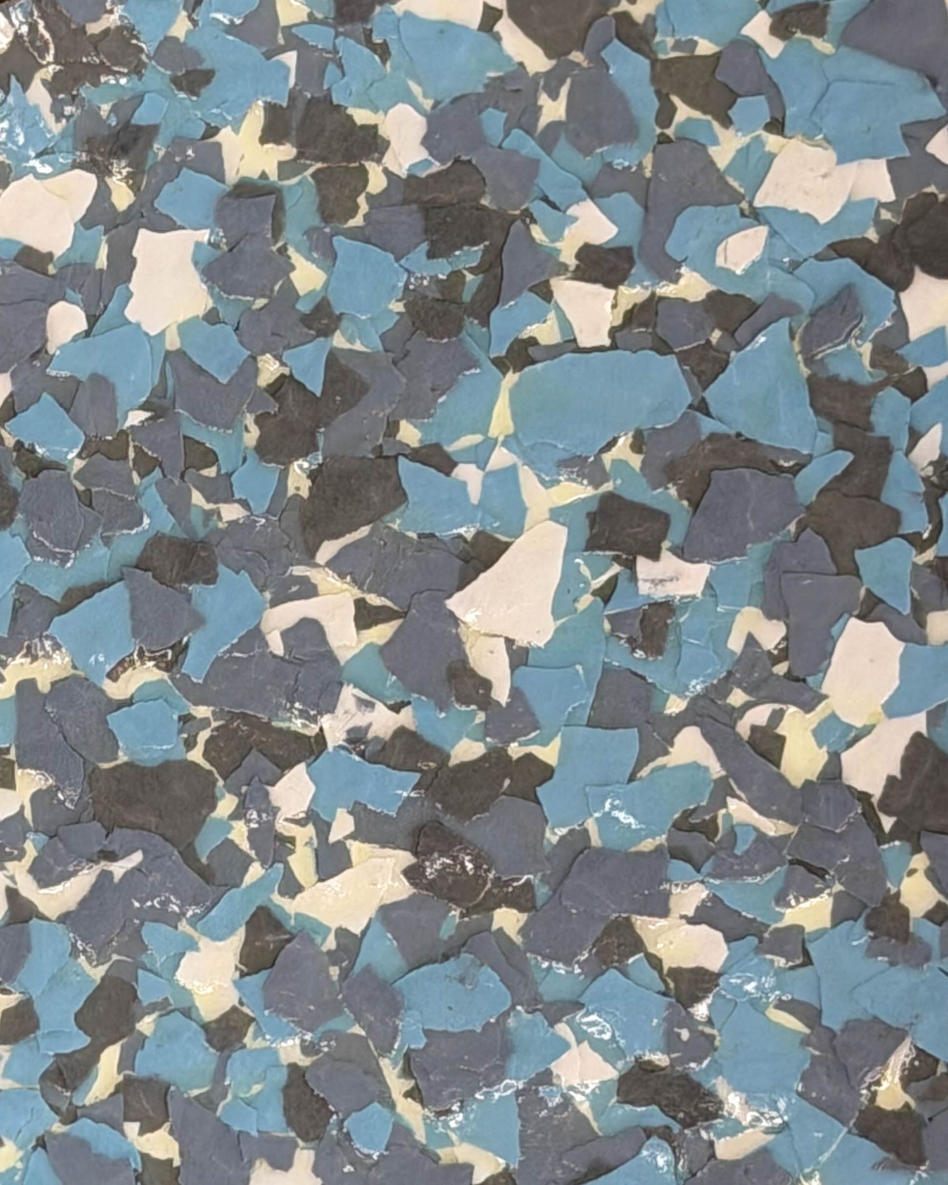 Blue, gray, black, and cream abstract confetti-like pattern filling the frame