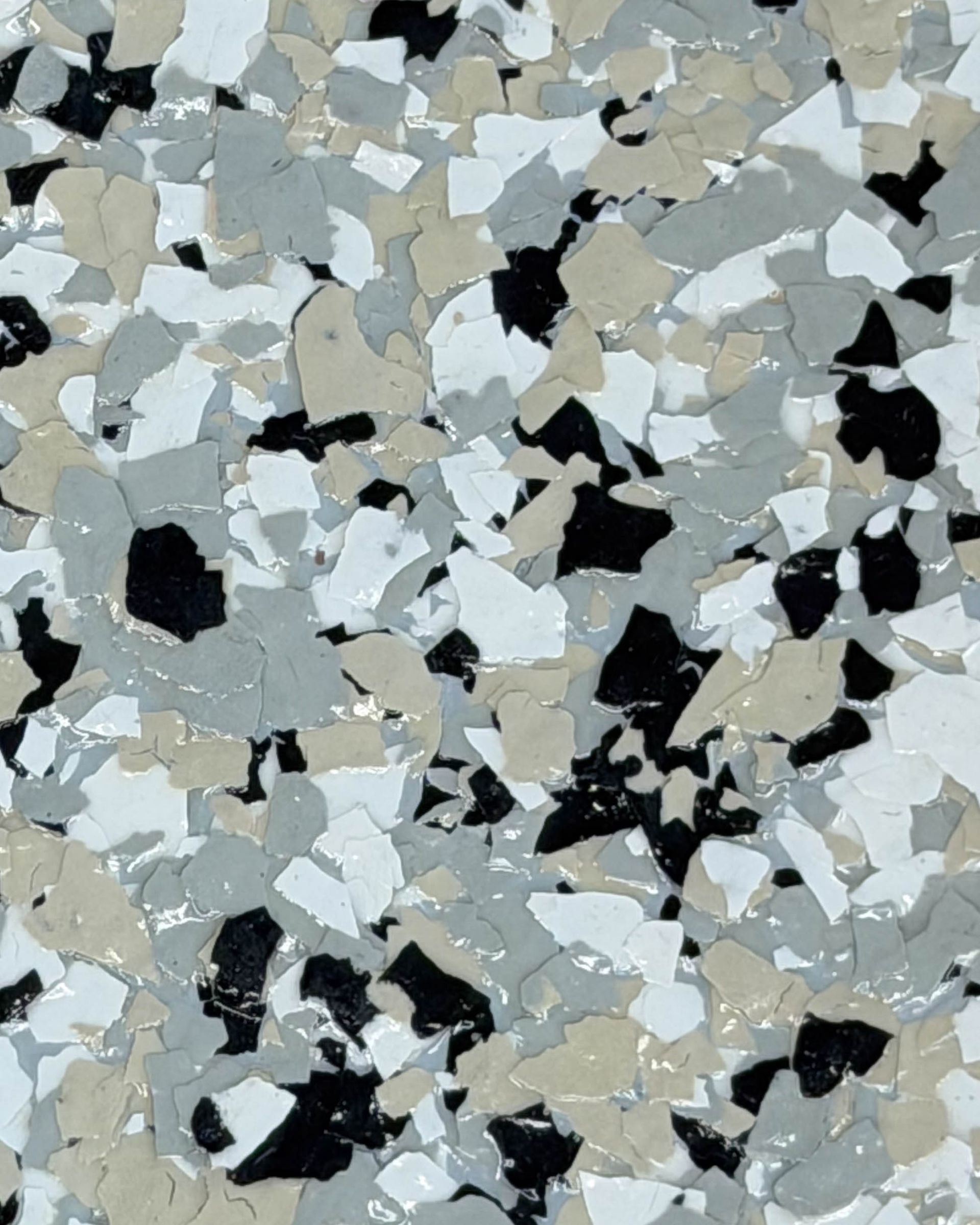 Gray, white, black, and beige speckled terrazzo floor surface