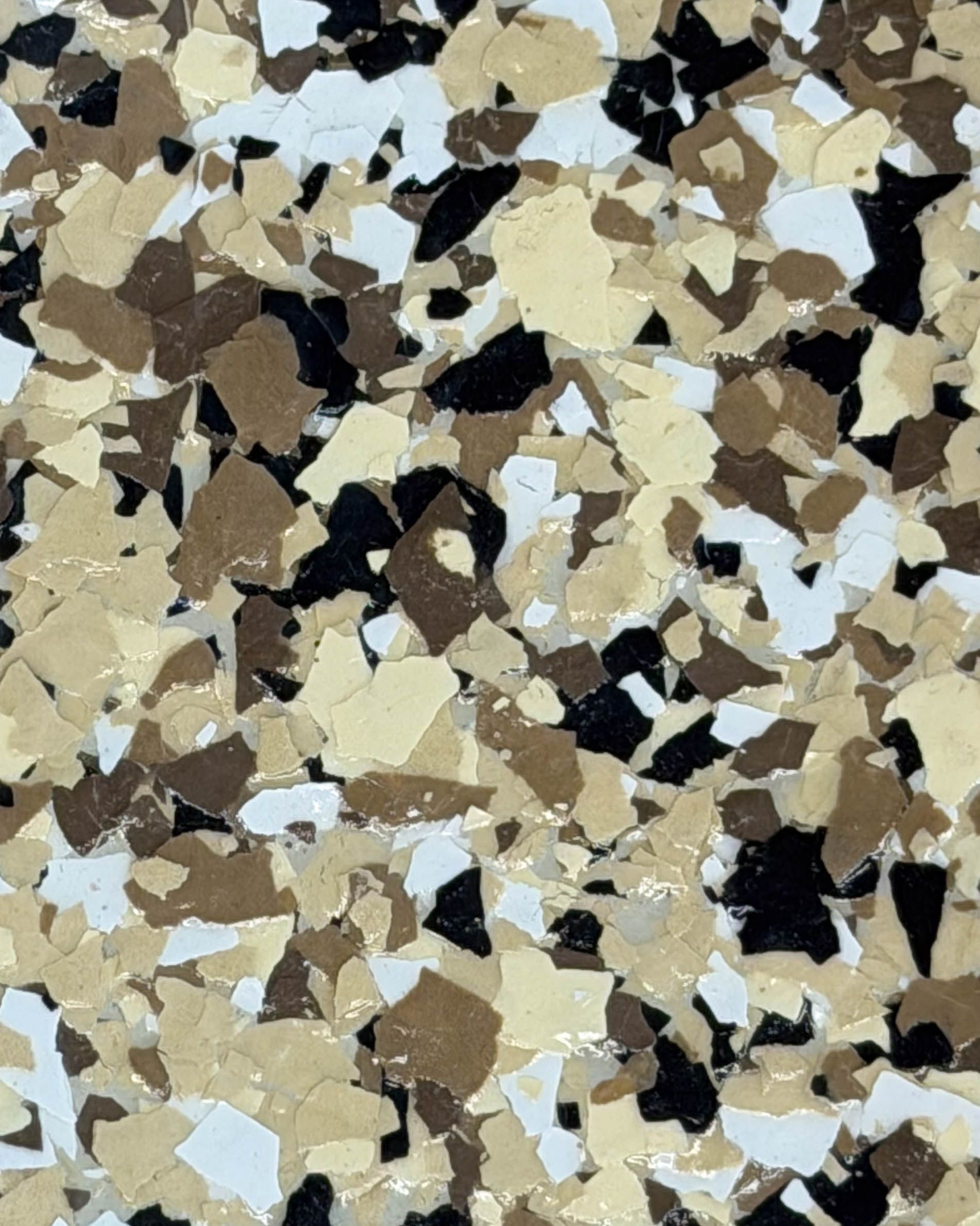 Abstract speckled terrazzo pattern in beige, brown, white, and black tones