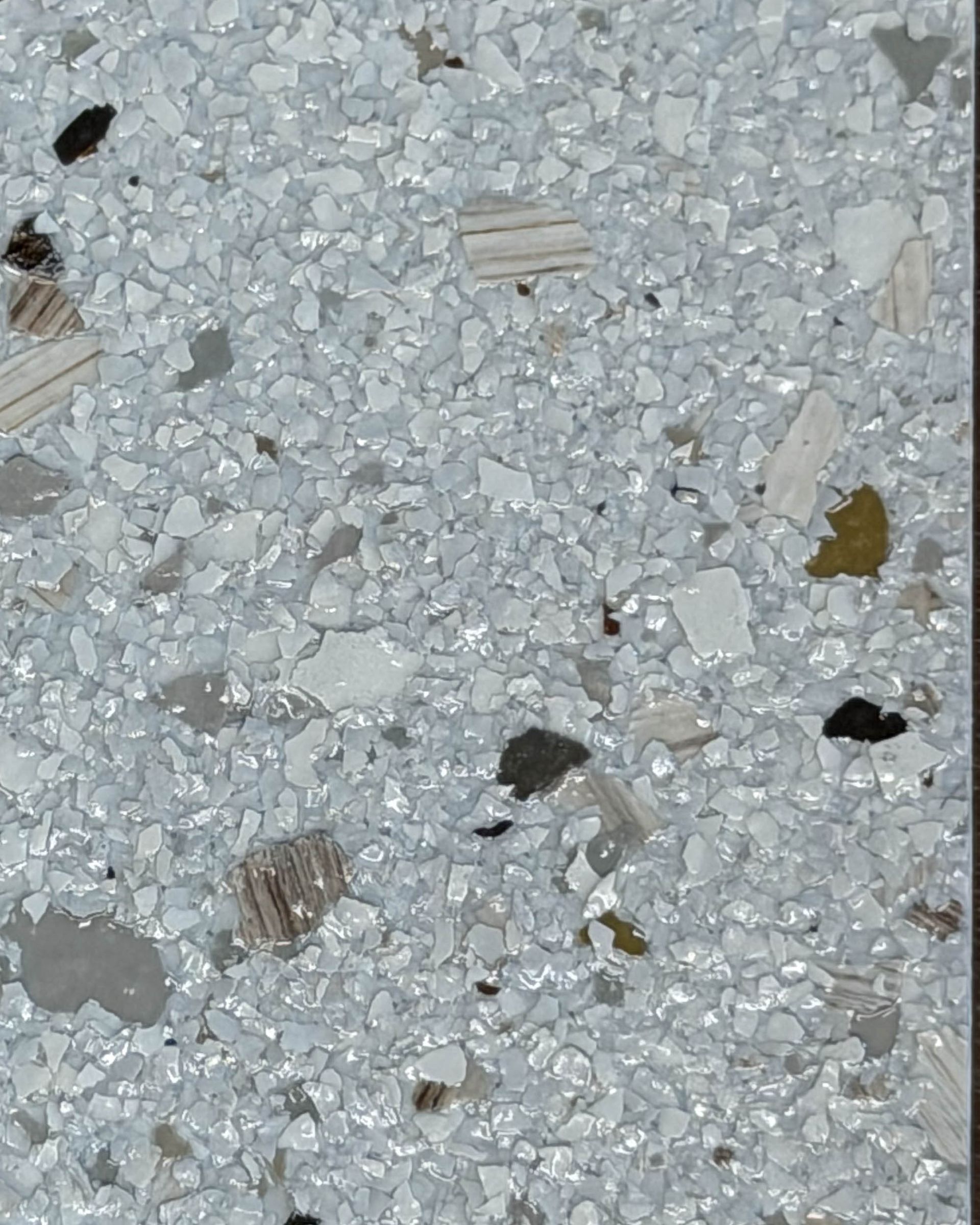 Close-up of light gray speckled terrazzo flooring with small stone chips