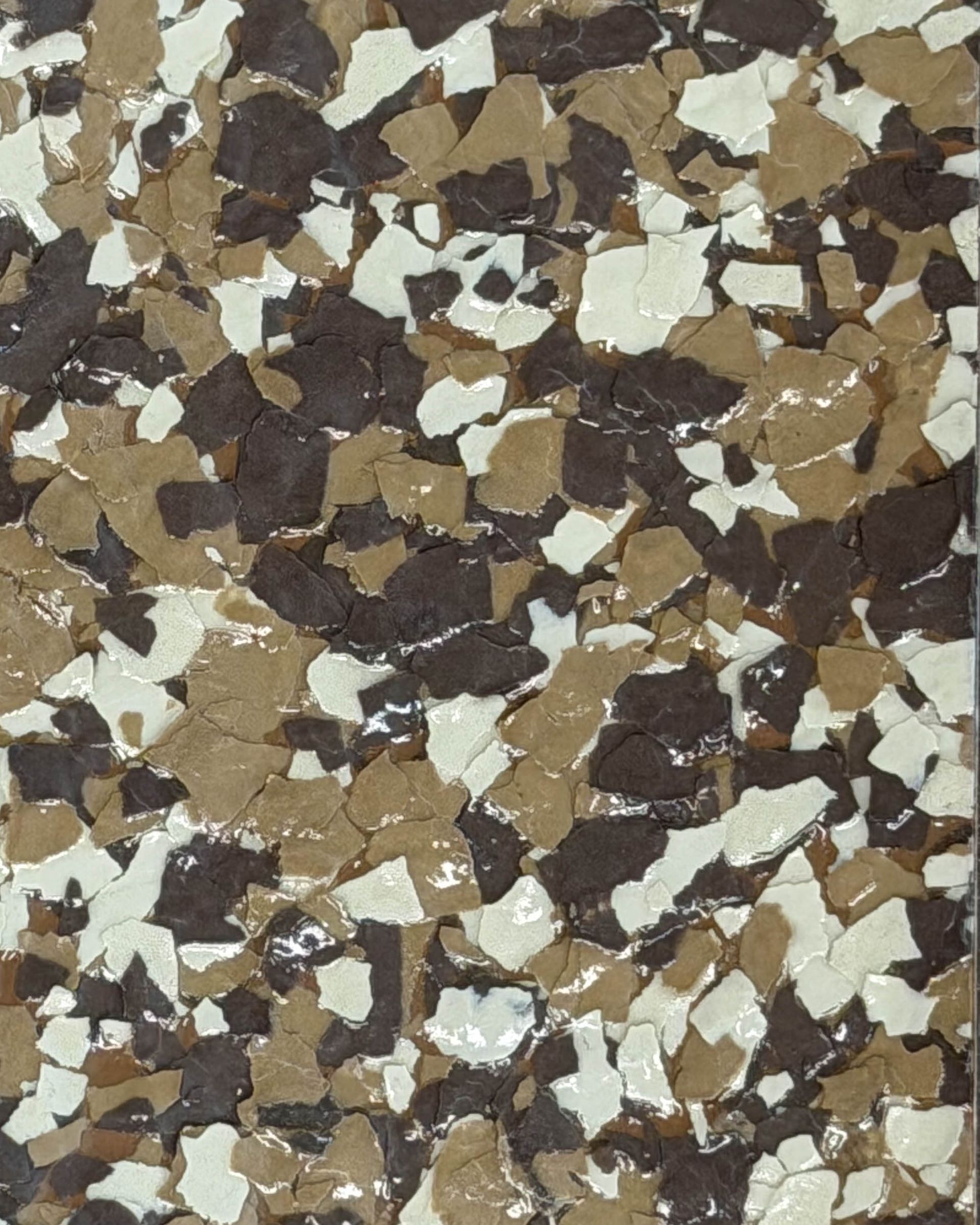 Close-up of a speckled terrazzo surface with brown, beige, and white stone chips