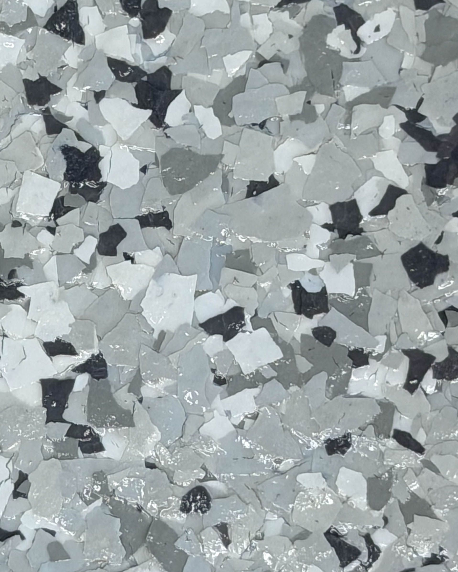 Close-up of silvery-gray metallic shards or crystals with a rough, textured surface