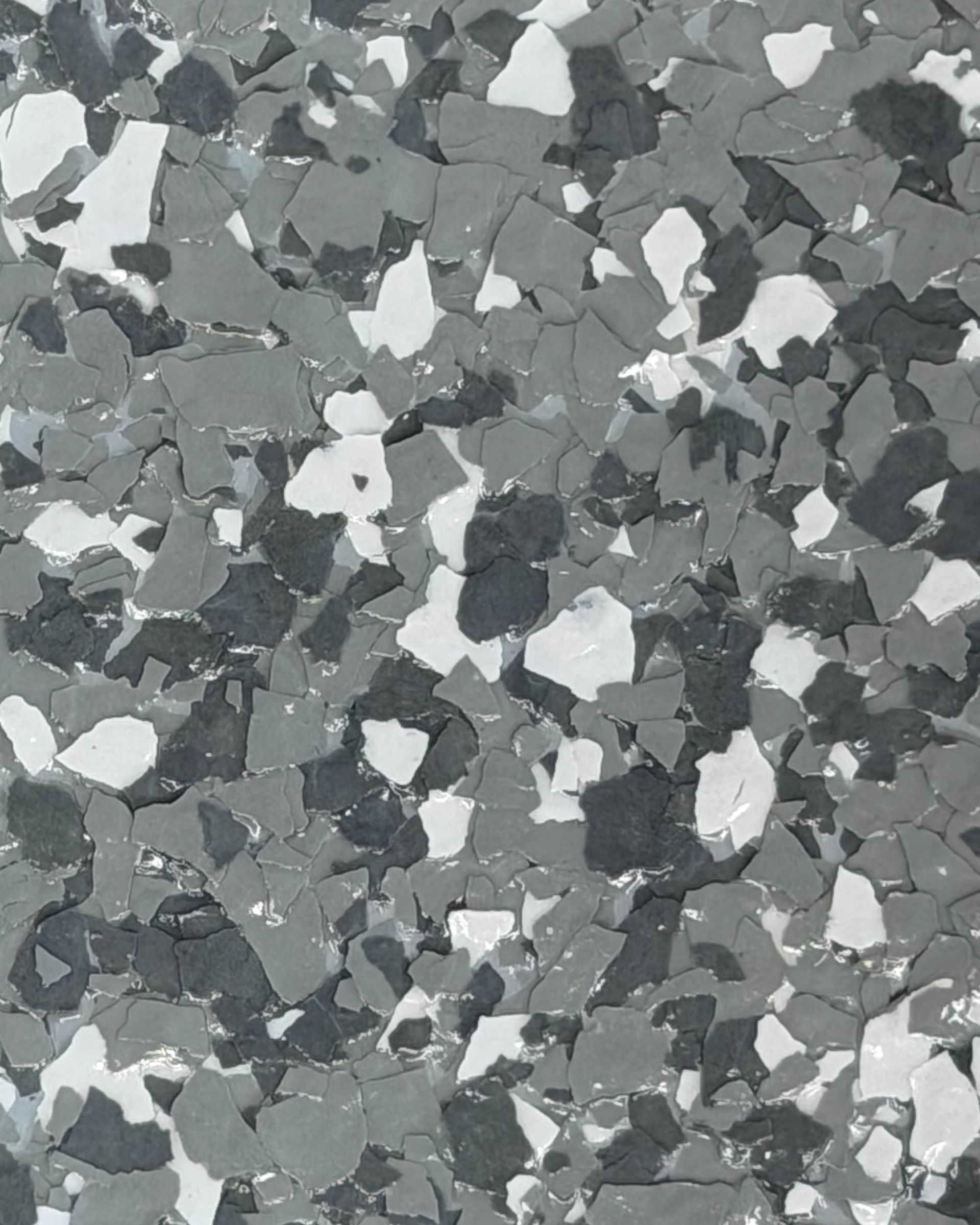 Close-up of light gray speckled terrazzo flooring with small colored stone chips