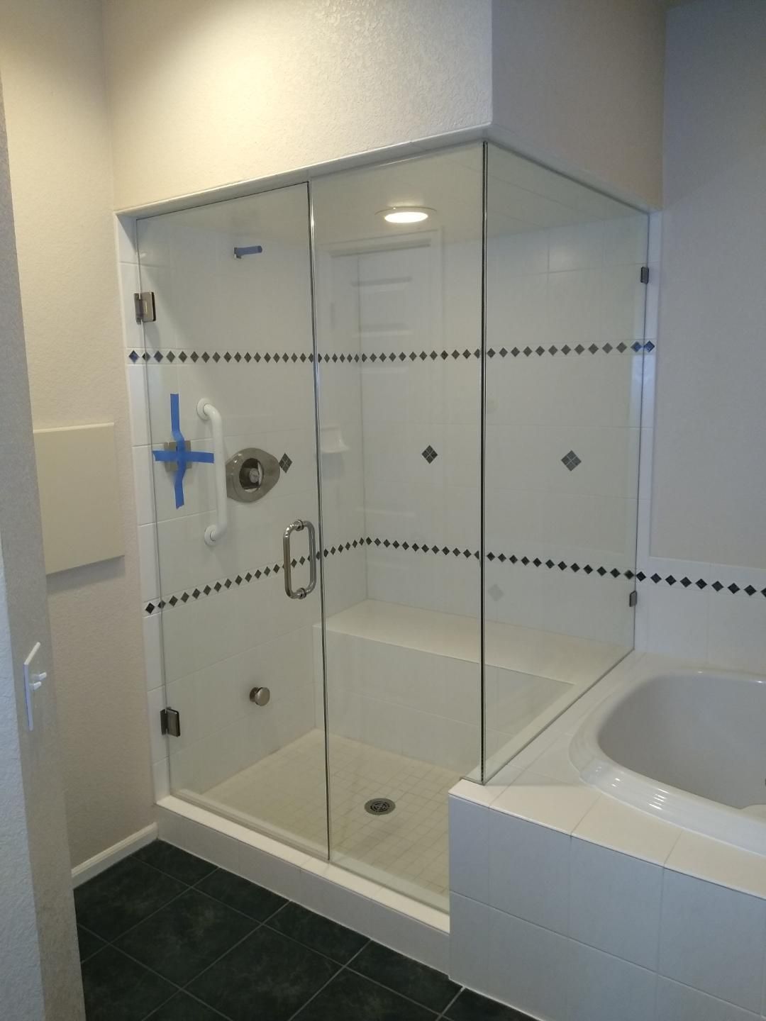 Custom frameless corner shower enclosure installed by Highlands Ranch Glass in Littleton, CO