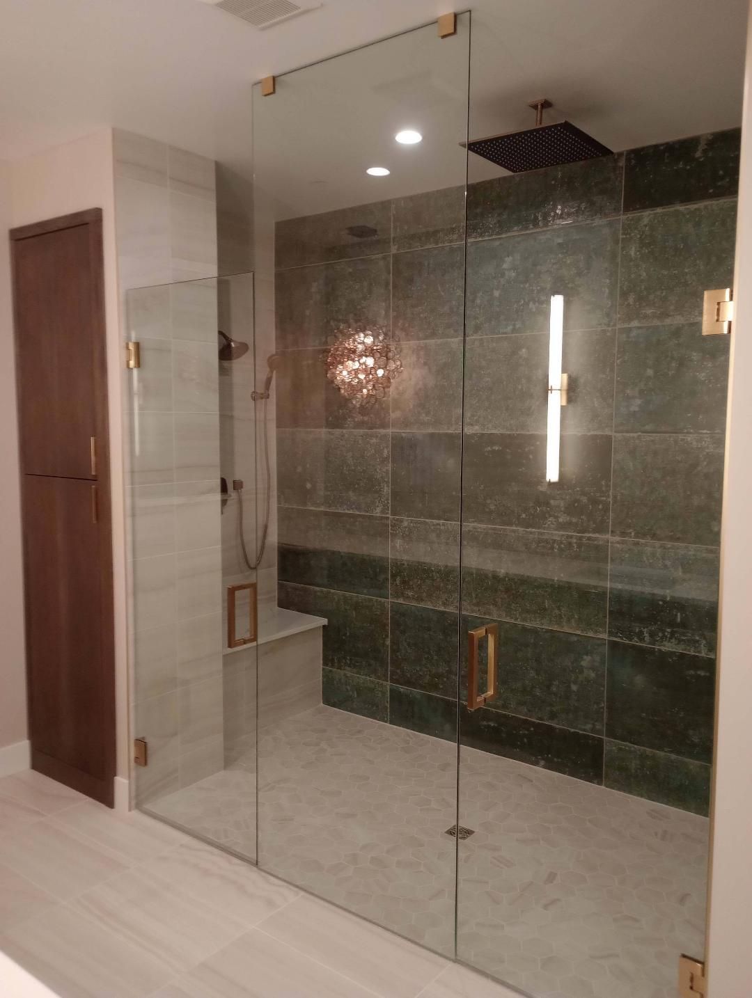 Napa frameless sliding shower door with return panel installed by Highlands Ranch Glass