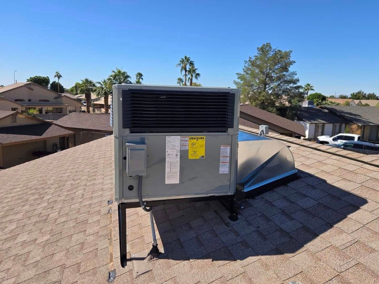 new Roof-mounted rooftop HVAC unit on a shingled house phoenix az