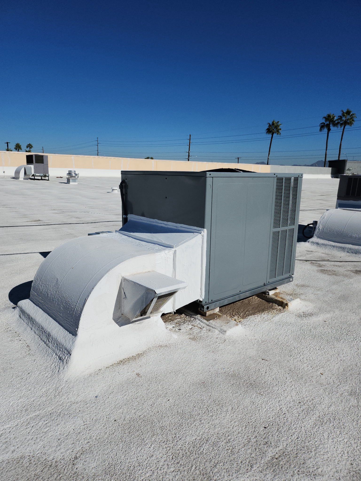 Large rooftop HVAC unit new install on a white gravel roof in Phoenix AZ