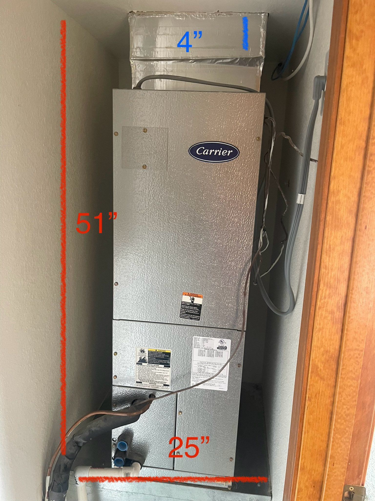 Gray HVAC unit in a narrow closet before replavce by a Western Sky Mechanical technician