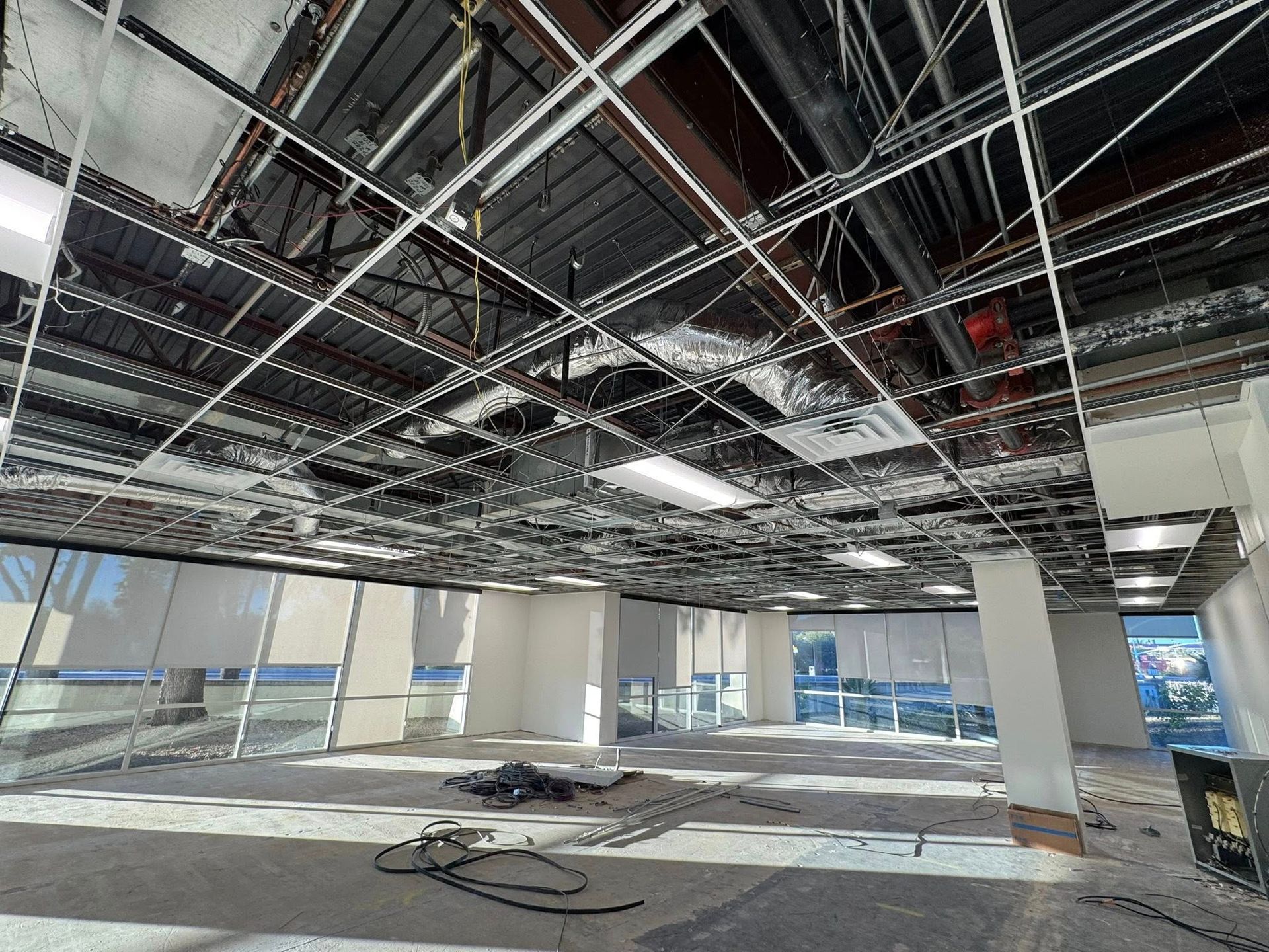 Unfinished phoenix office with Western Sky Mechanical installing ducting