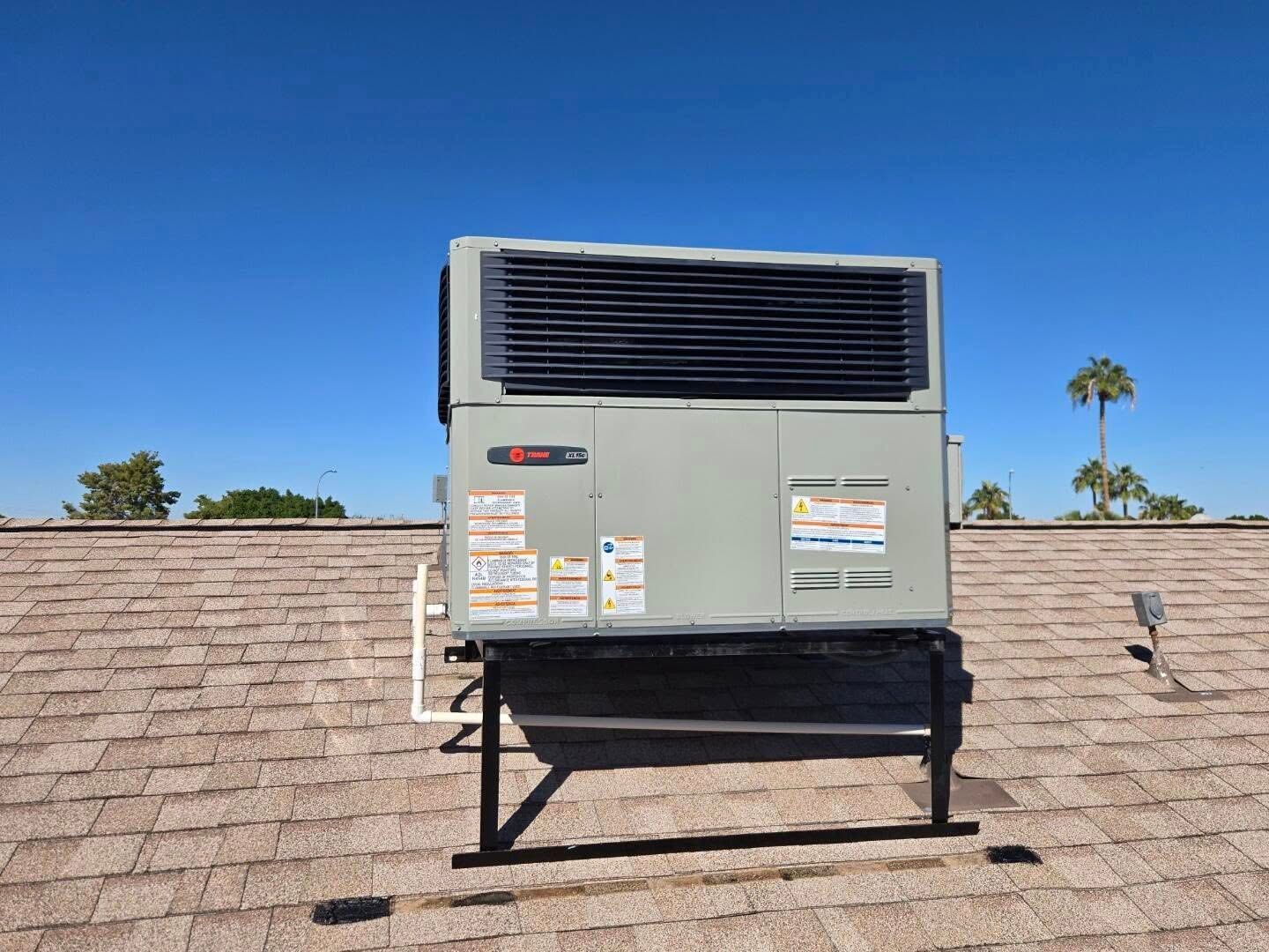 New Roof-mounted HVAC unit on a shingled rooftop Phoenix