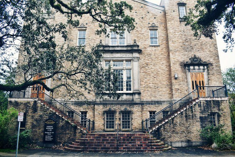 A large brick building with stairs leading up to it