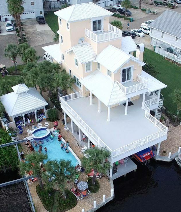 An aerial view of a large house with a swimming pool