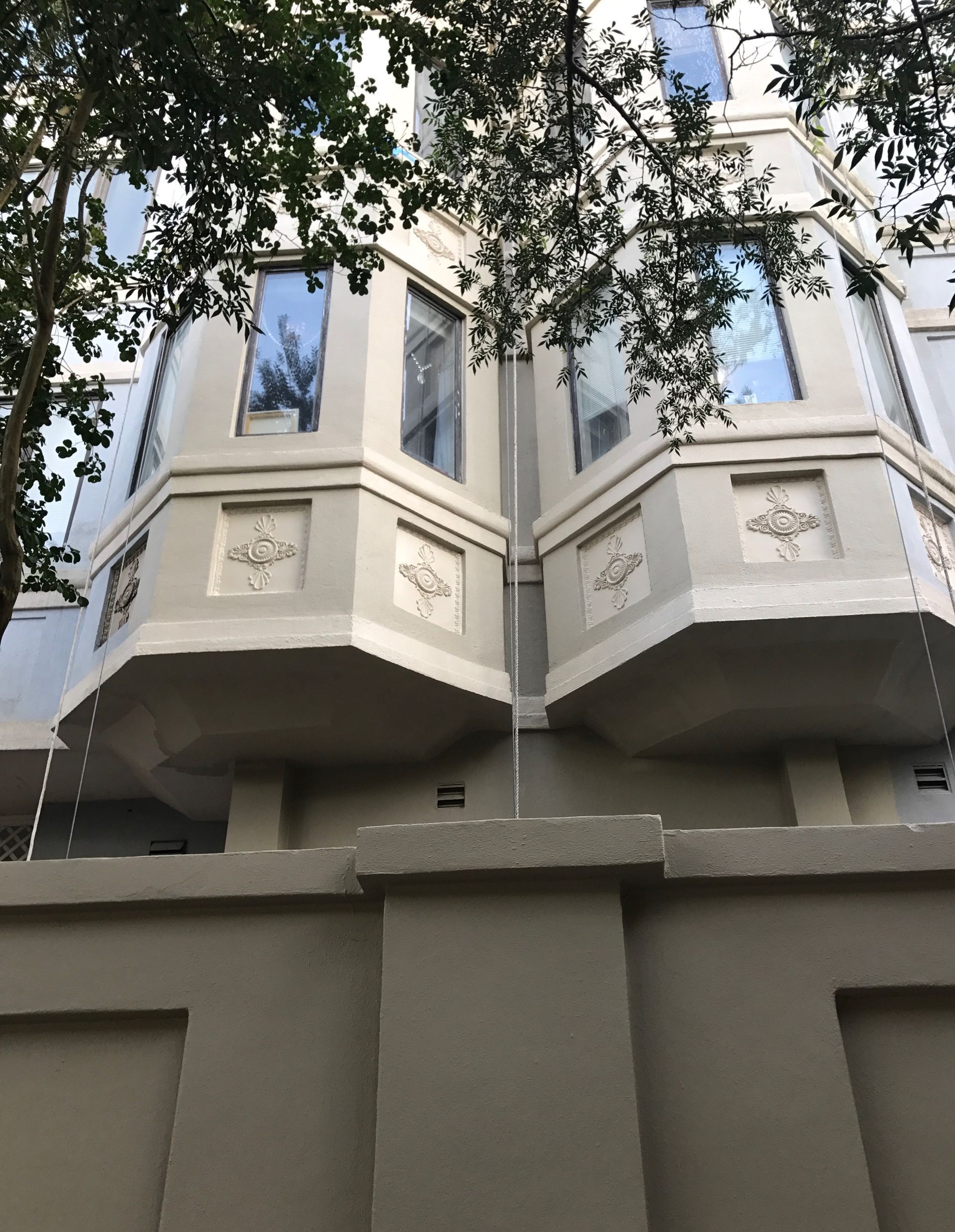 A building with a lot of windows and a fence in front of it