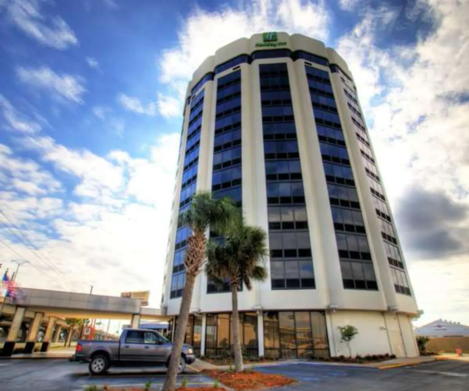 A large white building with the word holiday inn on it