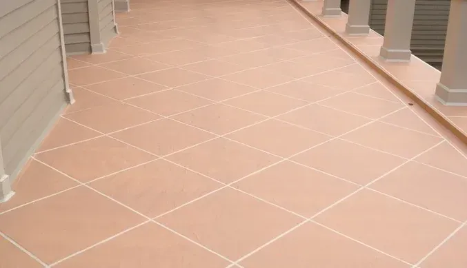 A tiled floor on a balcony with columns.