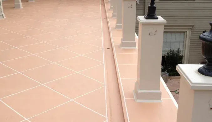 A tiled floor with columns and a lamp on top of it.