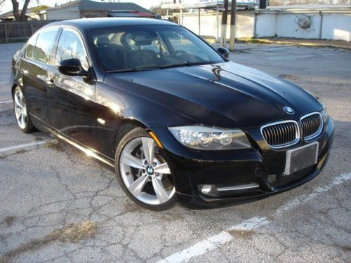 A black bmw is parked in a parking lot