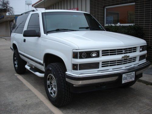A white chevrolet blazer is parked in a parking lot