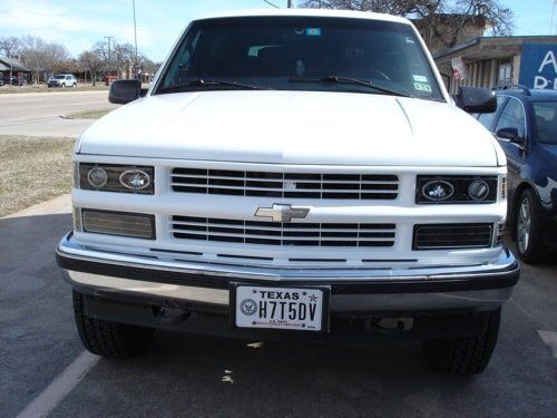 A white chevrolet truck with a texas license plate