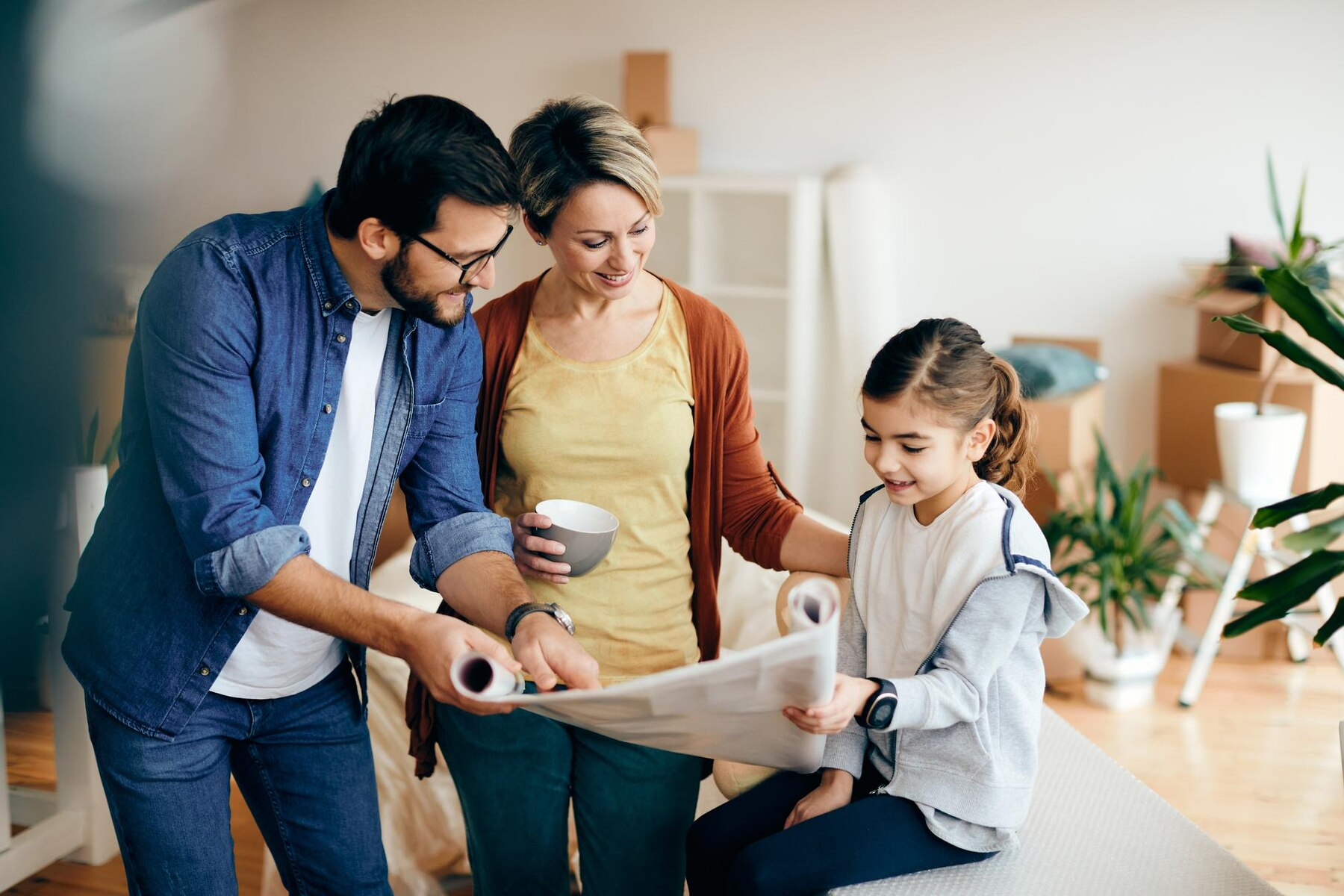 A family is looking at a blueprint of their new home.