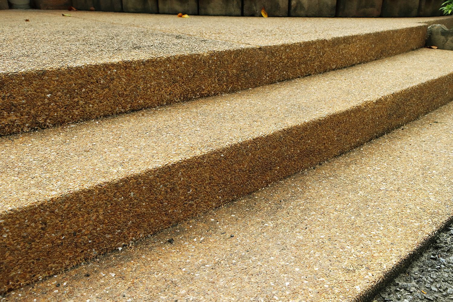 A close-up of exposed brown aggregate concrete steps. A close-up of exposed brown aggregate concrete steps.