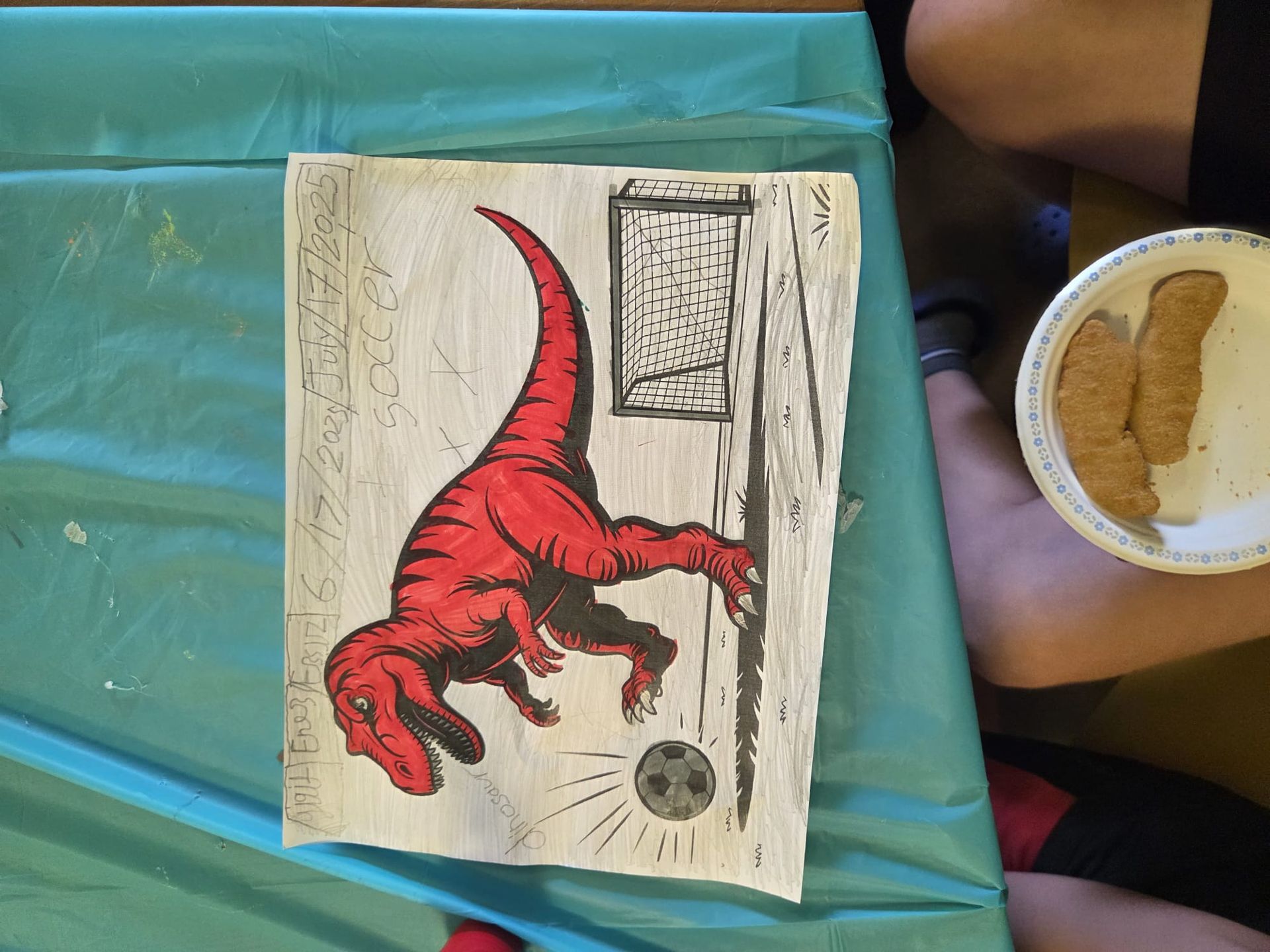 Red dinosaur kicking a soccer ball near a goal on a white background.