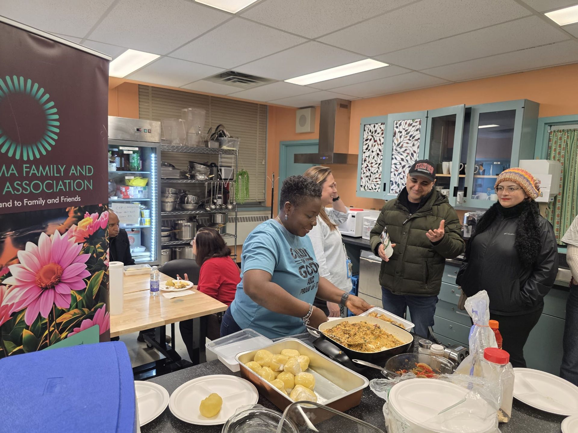 People in a kitchen preparing food; a banner for