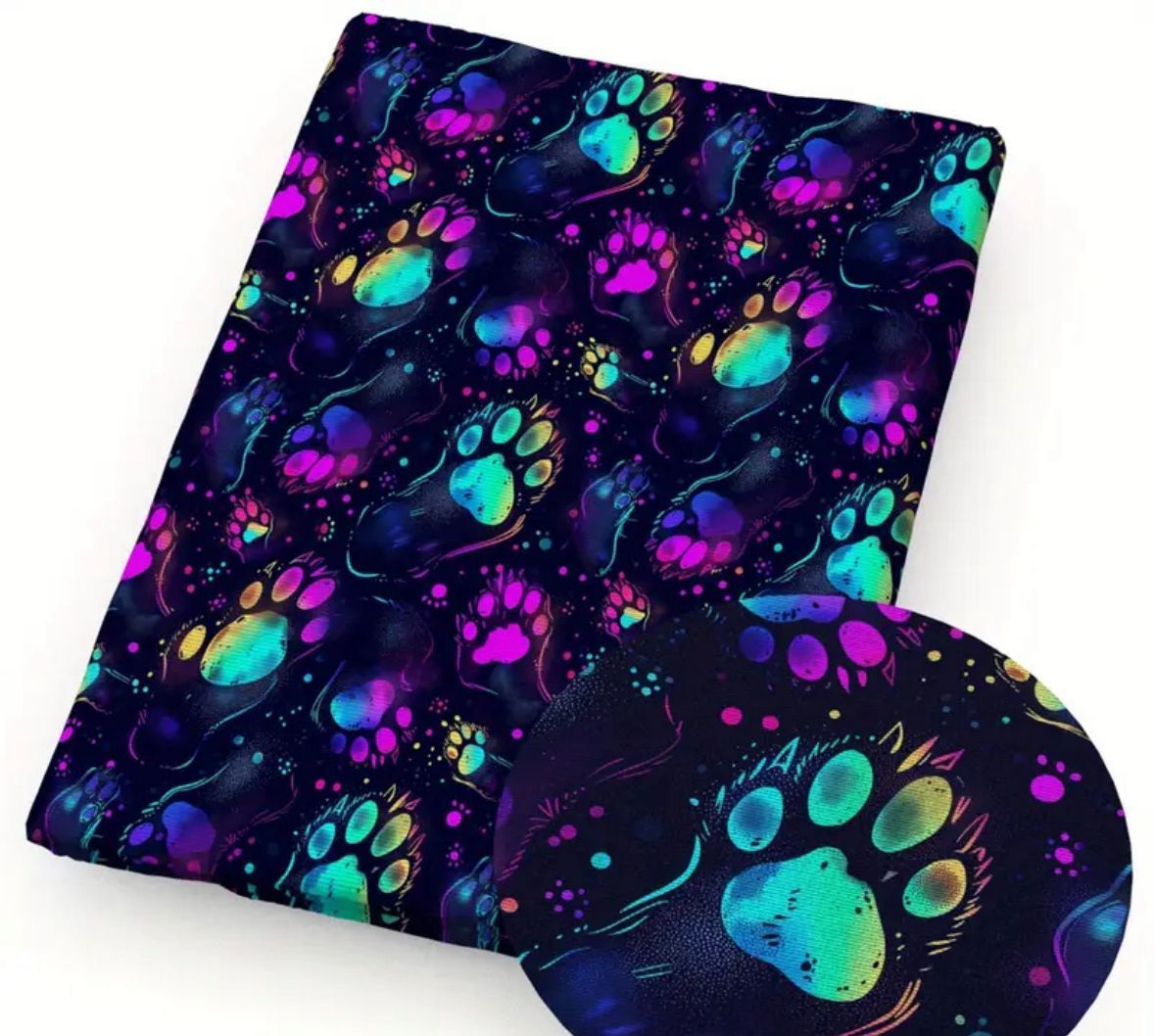 Black fabric with vibrant, colorful paw prints in blues, greens, and purples.