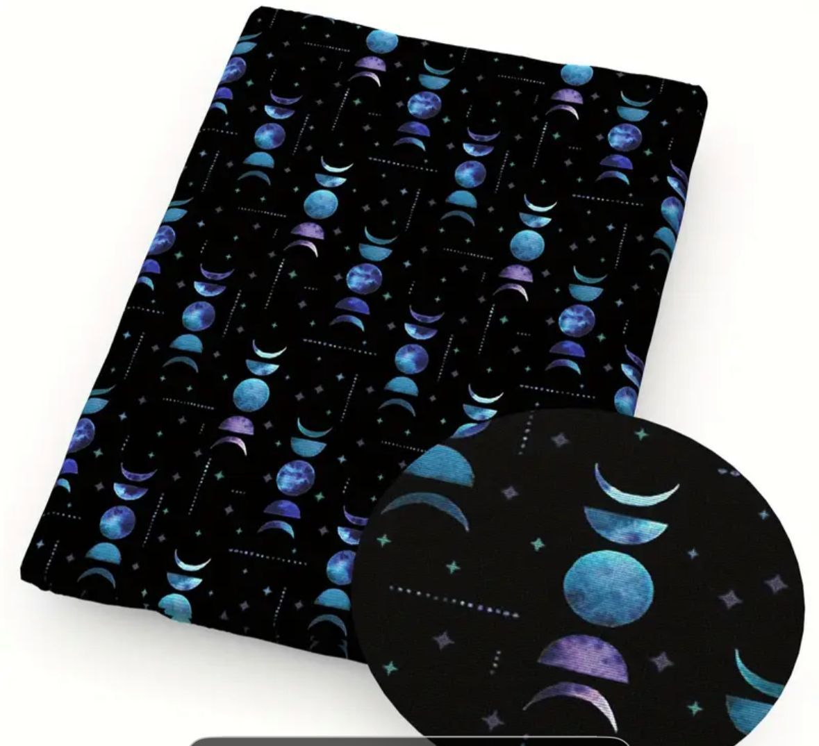 Black fabric with moon phases in shades of blue and purple. Stars sprinkled across the background.