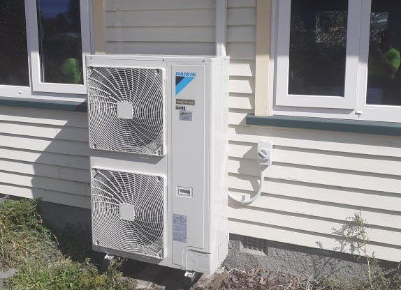Large Daikin outdoor heat pump installed.