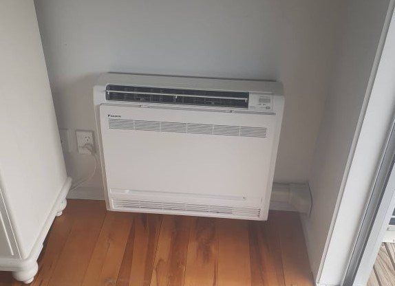 Installed floor console heat pump.