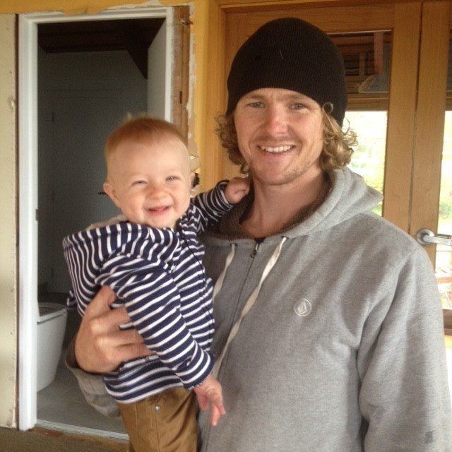 Man wearing a black beanie hat and son smiling.