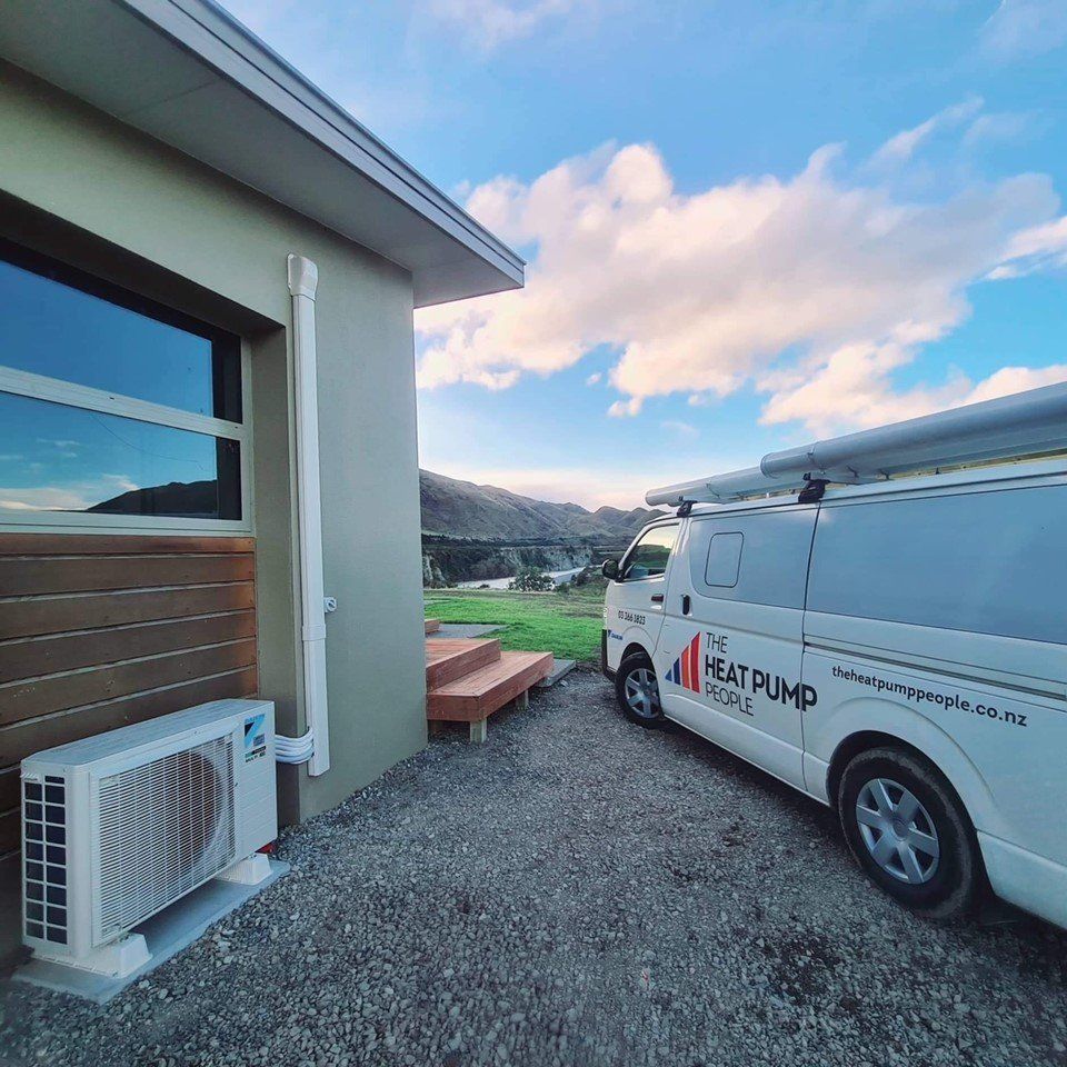 Outdoor heat pump unit with The Heat Pump People van