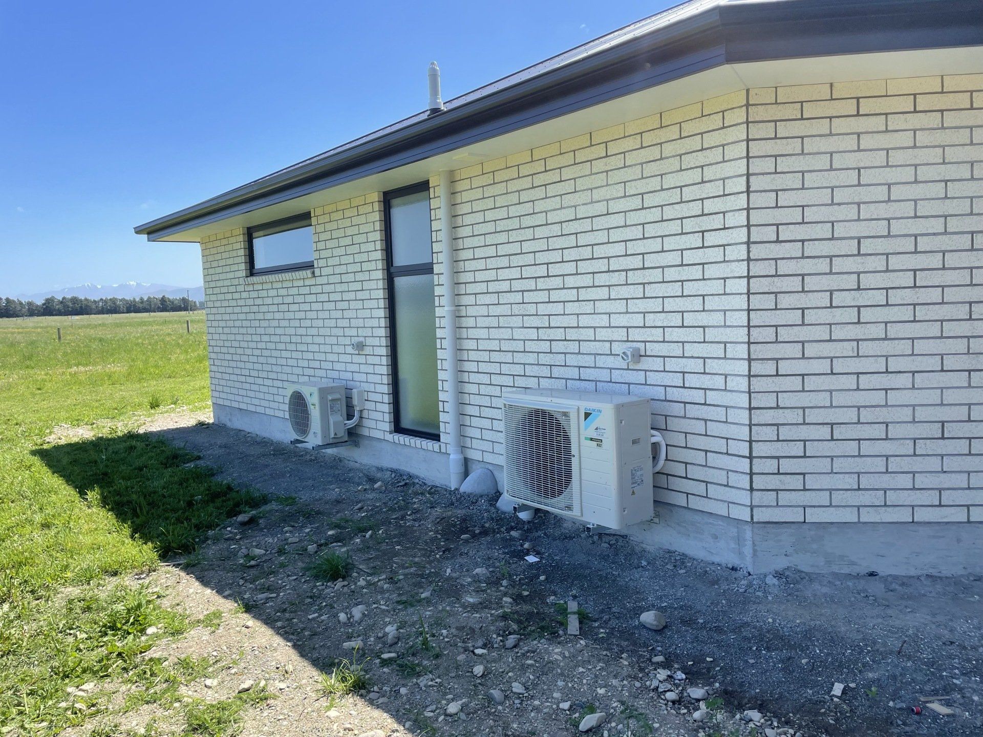 Outdoor heat pump unit outside new build house