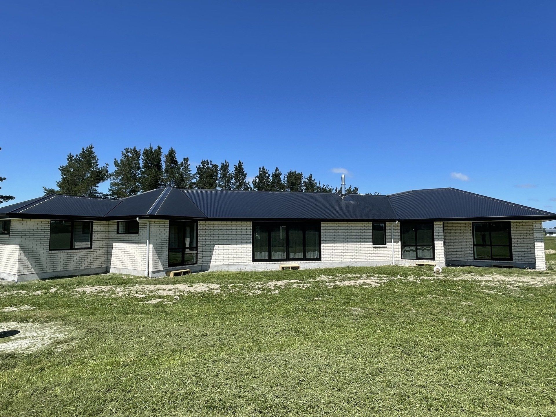 New build house with black roof and white bricks